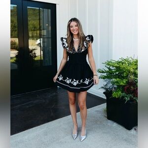 Elegant Black and White Embroidered Dress strut and bolt